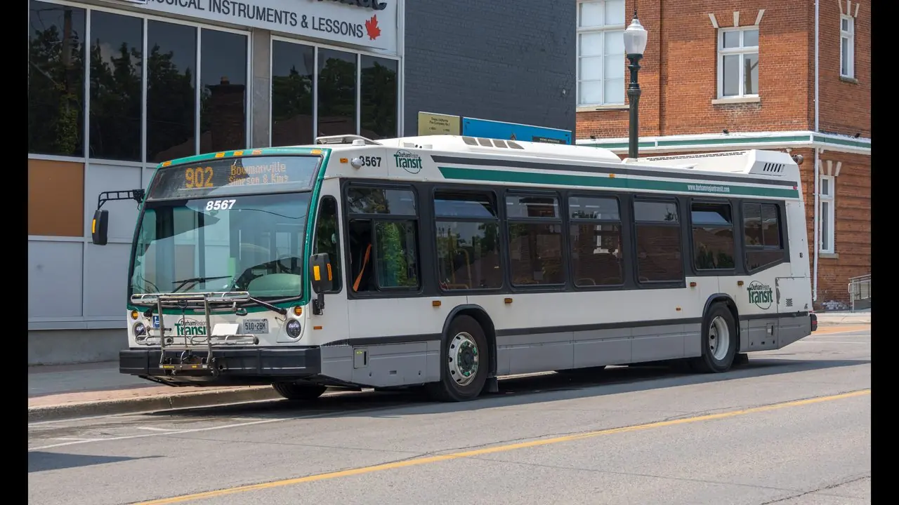 A Durham Region Transit bus (number 8567) on a street in Bowmanville, Ontario; no people visible.