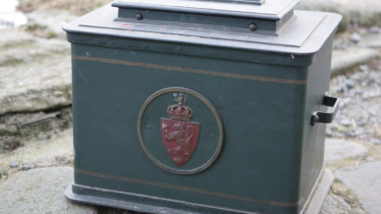 A vintage green ballot box on a stone surface; no people visible.